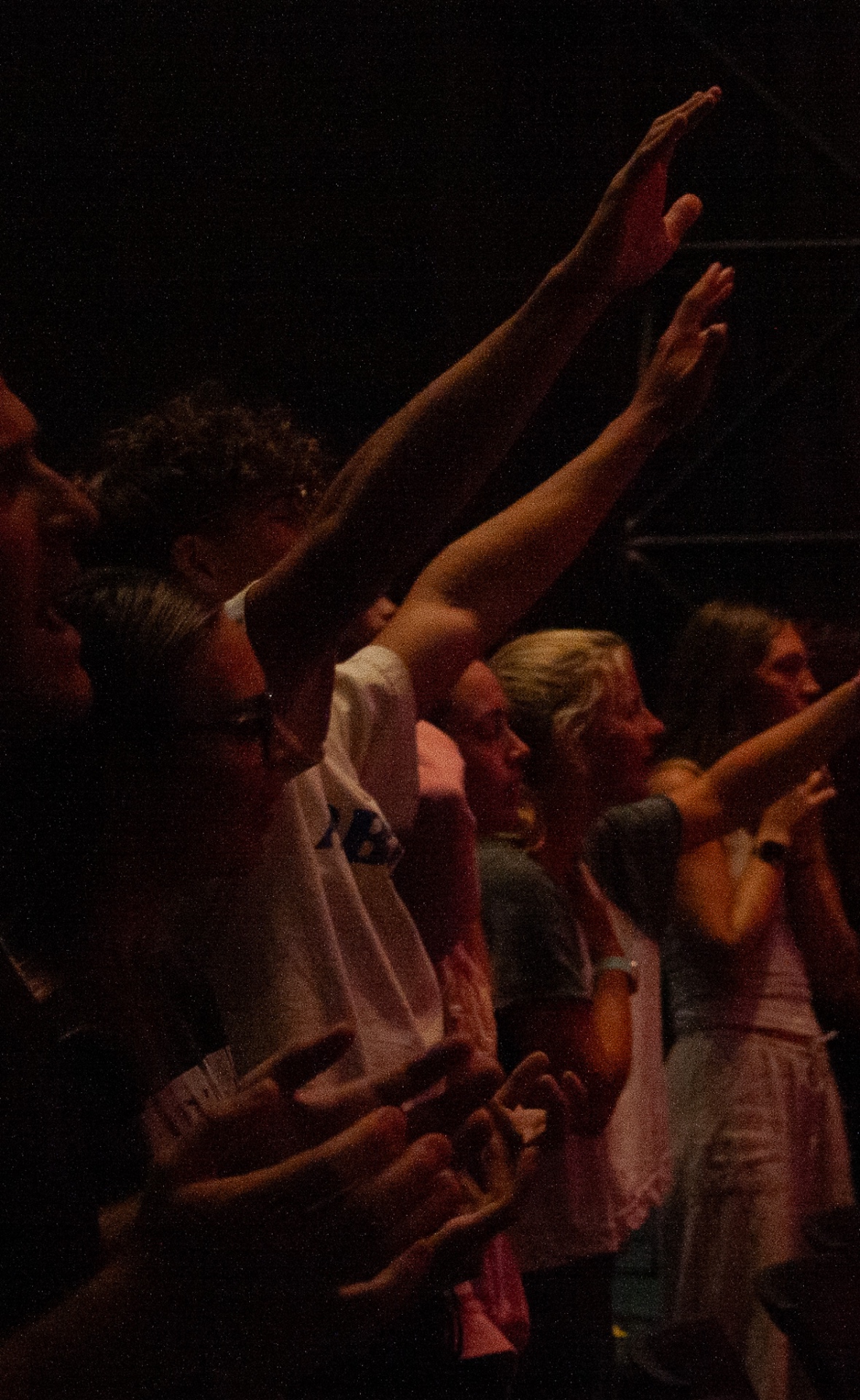 Hands raised in worship at Presence Night